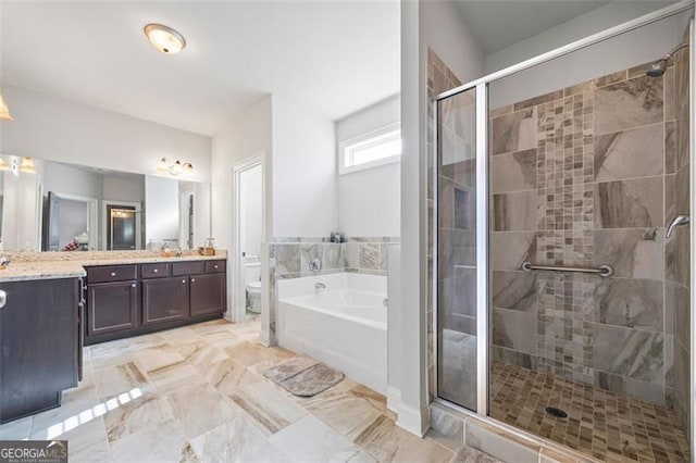 full bath featuring a stall shower, a garden tub, vanity, and toilet