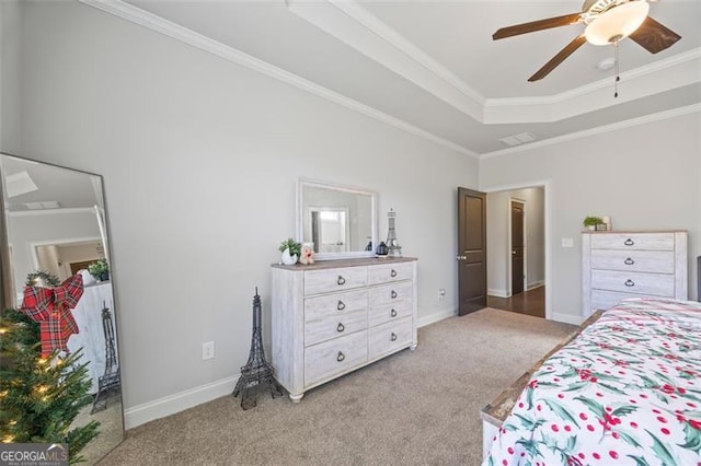 bedroom featuring a tray ceiling, light colored carpet, and crown molding