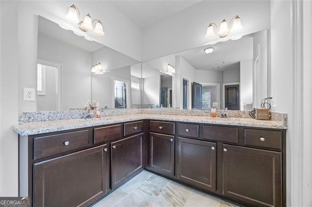 bathroom featuring a sink and double vanity