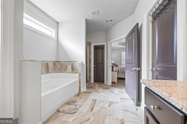 bathroom featuring a shower stall, visible vents, a bath, and vanity