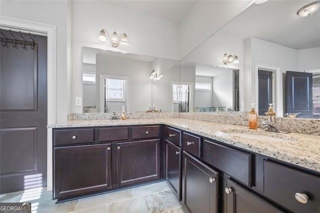 full bath with double vanity and a sink