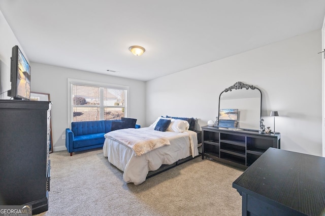 bedroom with visible vents and carpet flooring