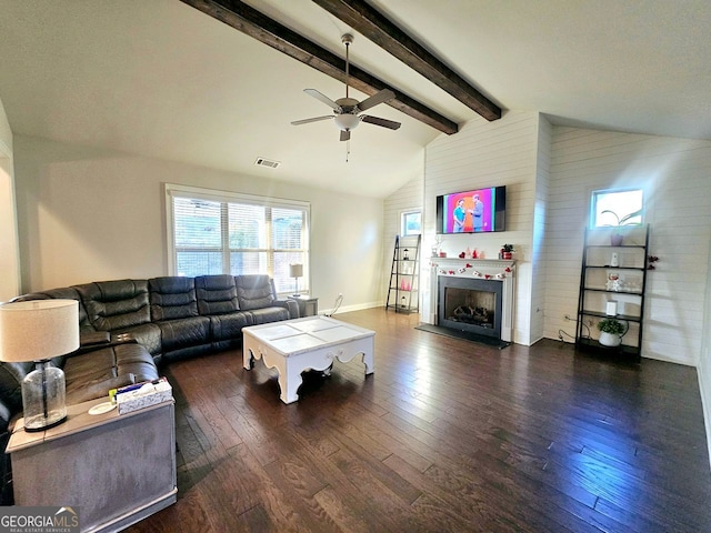 living room with visible vents, a ceiling fan, hardwood / wood-style floors, a fireplace, and beam ceiling