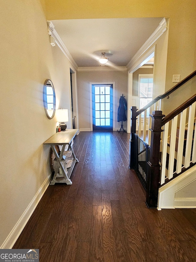 entrance foyer featuring stairway, baseboards, ornamental molding, and wood finished floors