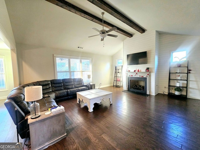 living room with wood-type flooring, ceiling fan, a fireplace, high vaulted ceiling, and beam ceiling