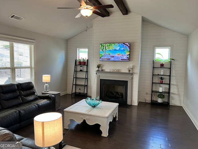 living area featuring dark wood-style flooring, visible vents, a fireplace, and lofted ceiling with beams