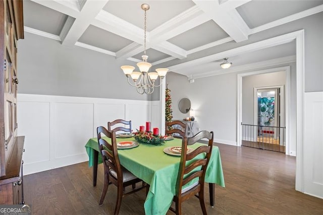 dining area featuring a notable chandelier, coffered ceiling, dark wood-type flooring, and beamed ceiling