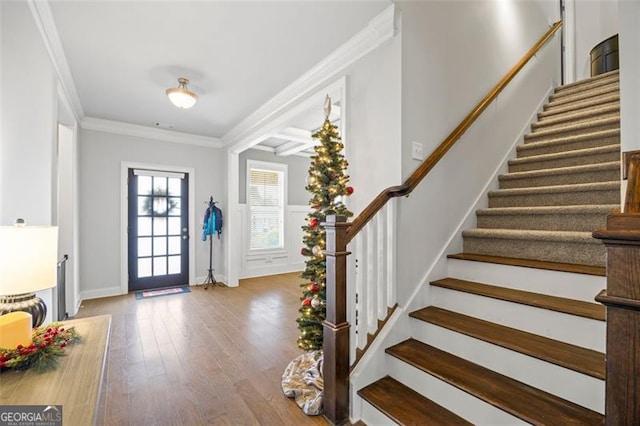 foyer entrance with crown molding, beamed ceiling, and wood-type flooring