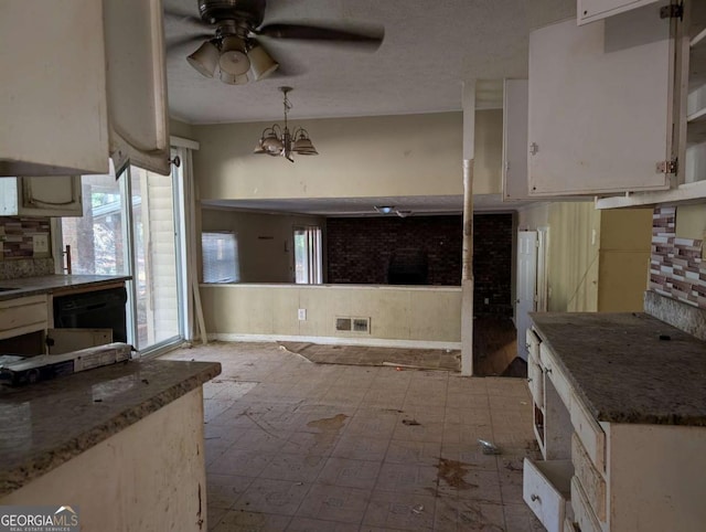 kitchen featuring decorative light fixtures, dishwasher, white cabinetry, and backsplash