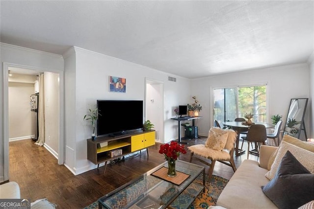 living room featuring dark hardwood / wood-style floors and ornamental molding