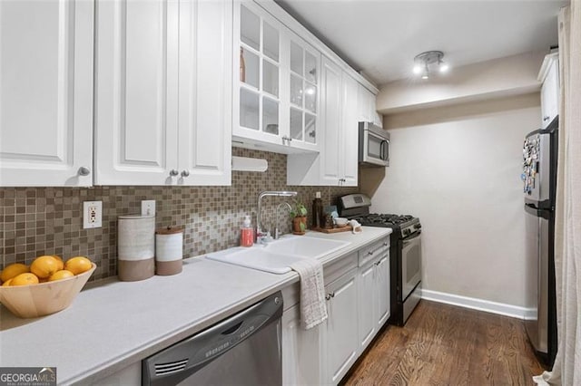 kitchen with dark hardwood / wood-style flooring, sink, white cabinetry, and stainless steel appliances