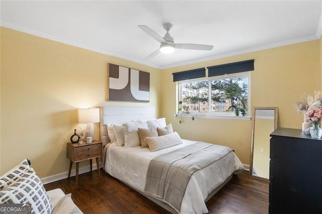 bedroom with ornamental molding, ceiling fan, and dark wood-type flooring