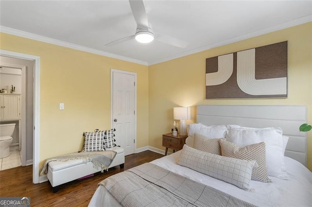 bedroom with ceiling fan, dark hardwood / wood-style flooring, ensuite bathroom, and crown molding