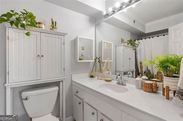 bathroom with a shower with curtain, vanity, toilet, and ornamental molding