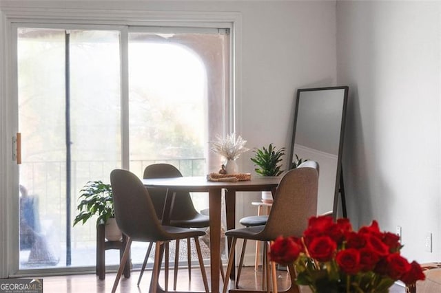 dining space with wood-type flooring