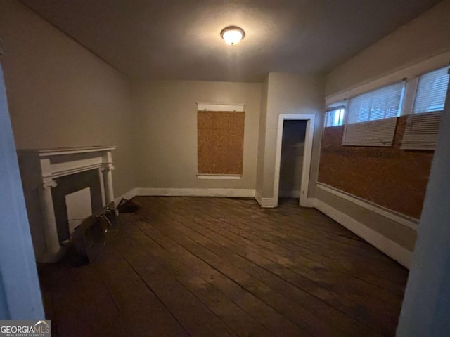 unfurnished living room with dark wood-type flooring