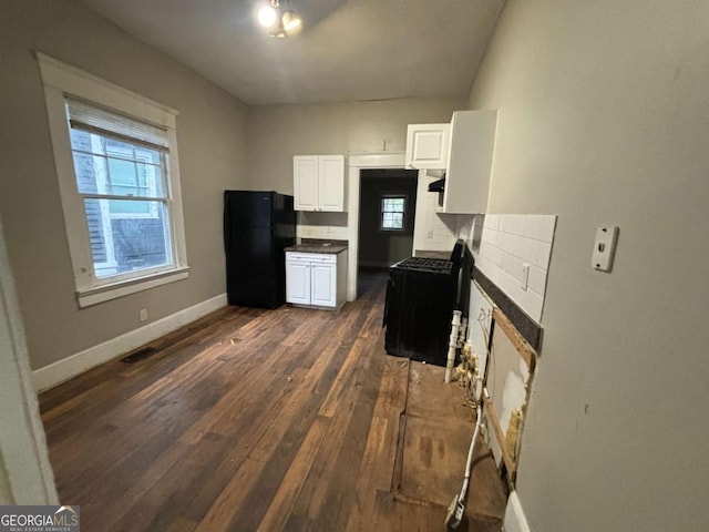 kitchen featuring black appliances, white cabinetry, and dark wood-type flooring