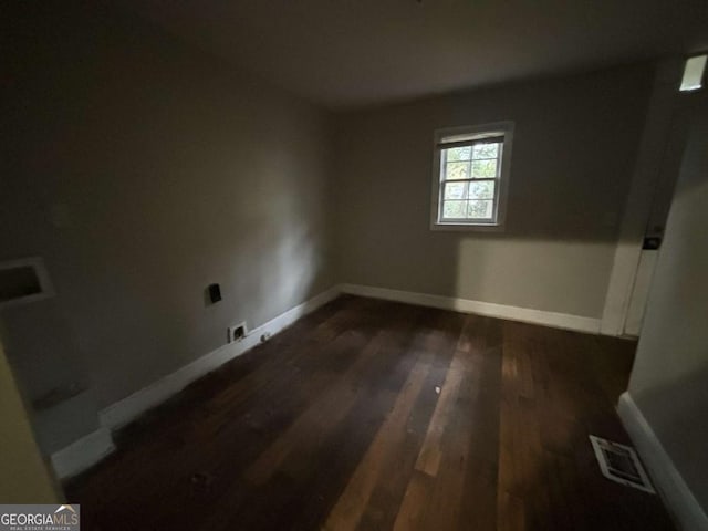 spare room featuring dark hardwood / wood-style flooring