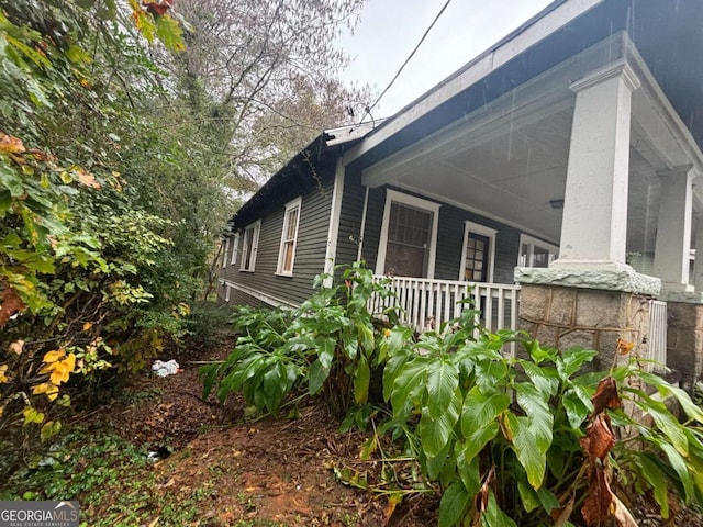 view of property exterior featuring covered porch