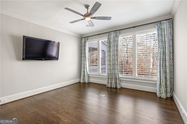 unfurnished room with a healthy amount of sunlight, ornamental molding, and dark wood-type flooring