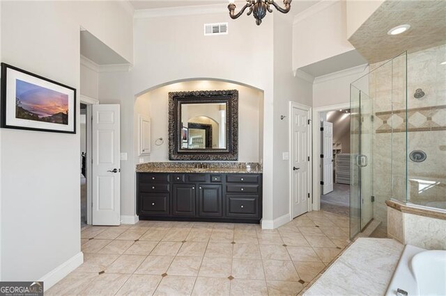 bathroom with a towering ceiling, ornamental molding, vanity, independent shower and bath, and a notable chandelier