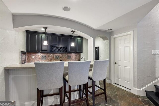 bar featuring decorative backsplash