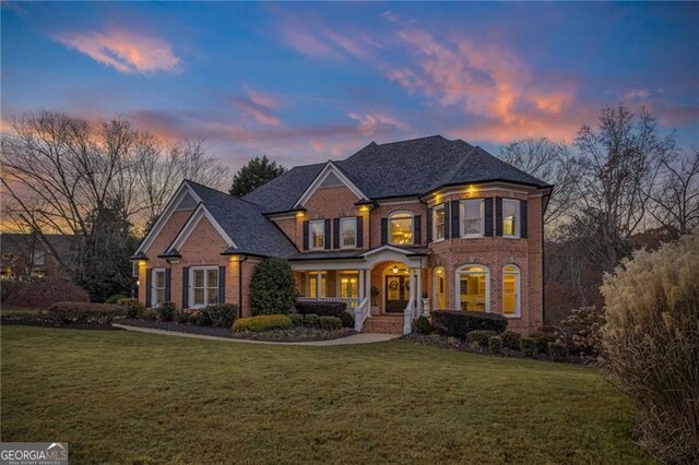 view of front of home featuring a porch and a lawn