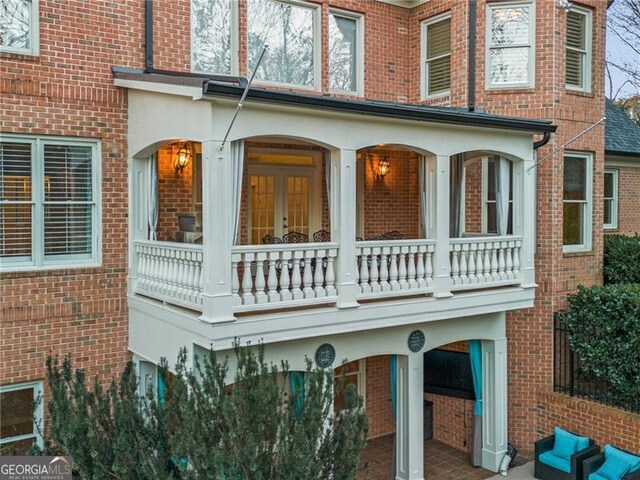 view of side of home featuring a balcony