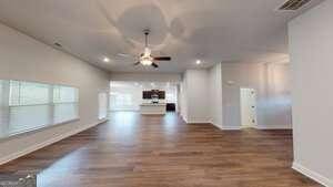 empty room featuring ceiling fan and dark wood-type flooring