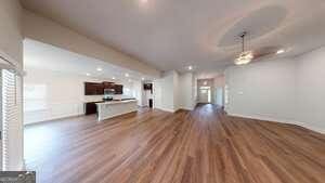 unfurnished living room with dark hardwood / wood-style flooring