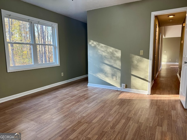 unfurnished room featuring wood-type flooring