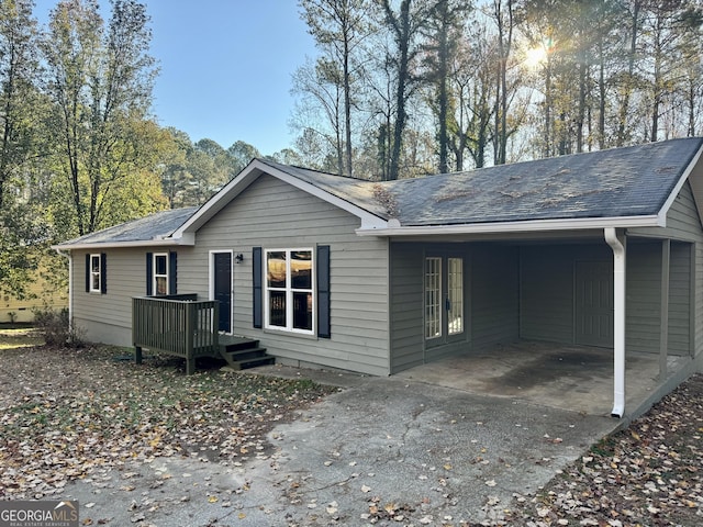 back of house with a carport