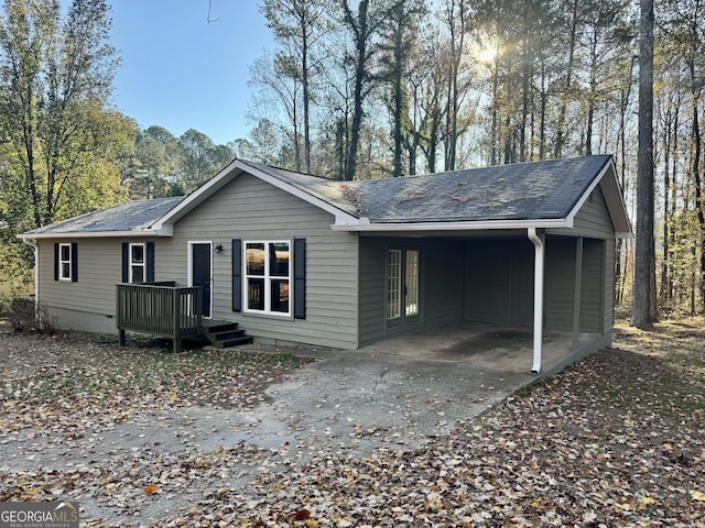 back of house with a carport