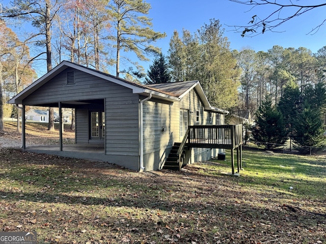 view of home's exterior featuring a yard, a patio, and a deck