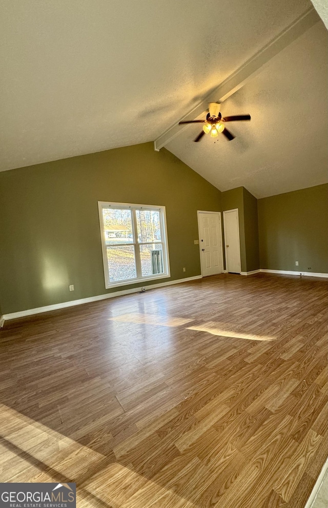 interior space with hardwood / wood-style floors, lofted ceiling with beams, and ceiling fan