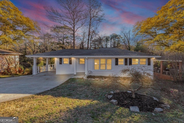 single story home with a carport and a yard