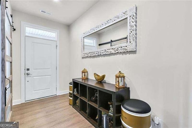 foyer entrance with hardwood / wood-style flooring