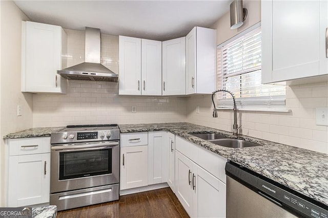 kitchen featuring white cabinetry, dark hardwood / wood-style flooring, wall chimney exhaust hood, and appliances with stainless steel finishes