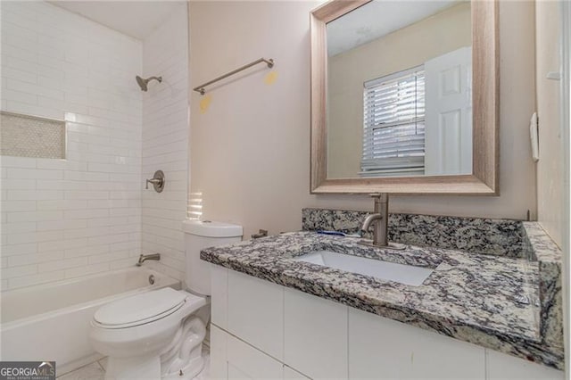 full bathroom featuring toilet, vanity, and tiled shower / bath