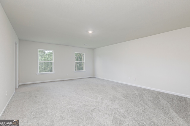 unfurnished room with light carpet