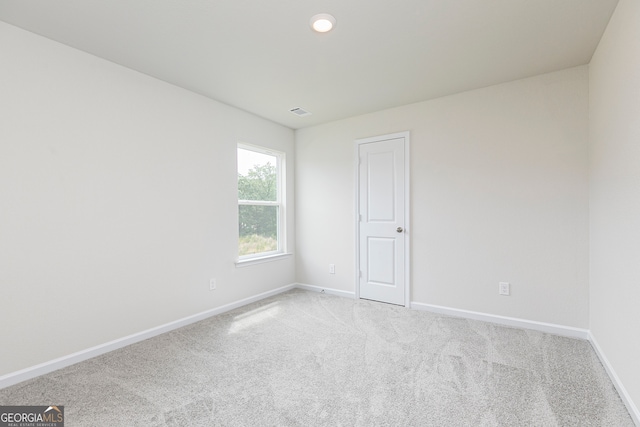 unfurnished room with light carpet