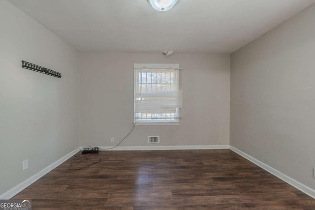 empty room with dark hardwood / wood-style floors