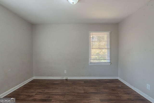 spare room with dark hardwood / wood-style flooring