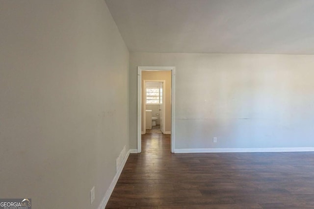 empty room featuring dark wood-type flooring