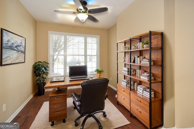 office area with dark wood-type flooring, baseboards, and ceiling fan