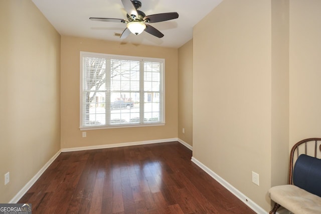 interior space with dark wood finished floors, baseboards, and ceiling fan