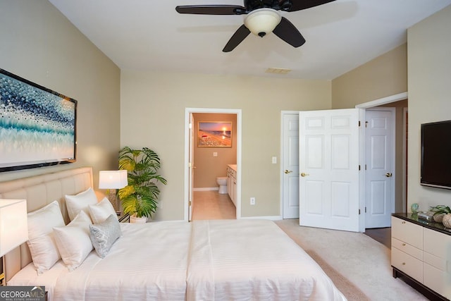 bedroom with visible vents, light carpet, a ceiling fan, and ensuite bathroom