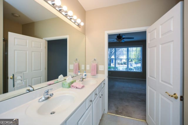 bathroom featuring double vanity, ceiling fan, and a sink