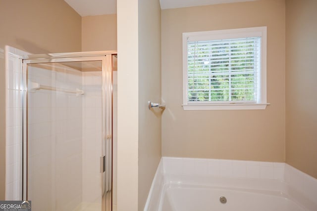 bathroom featuring a bath and a stall shower