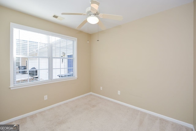 unfurnished room featuring visible vents, ceiling fan, baseboards, and carpet